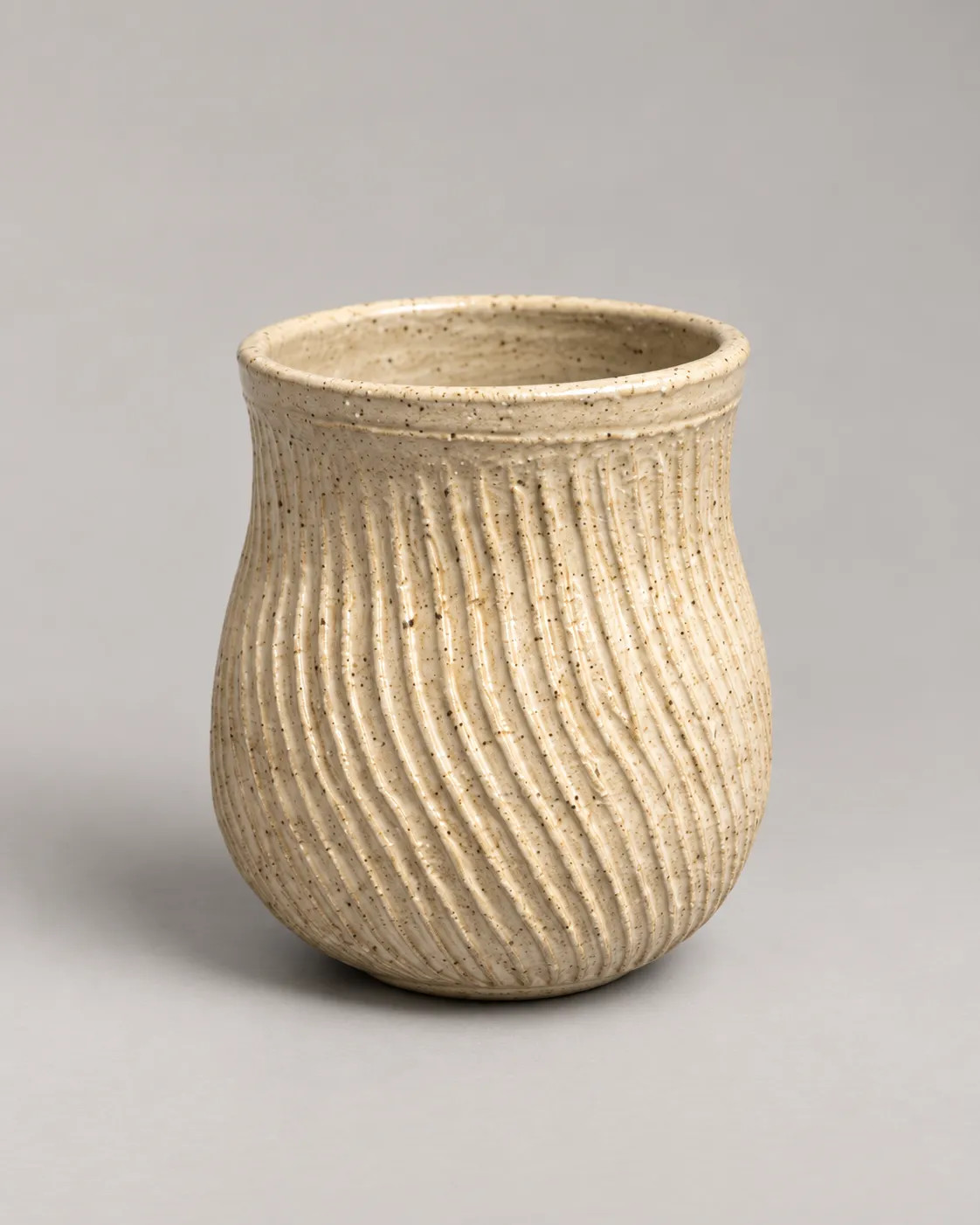 Tall speckled cream cup with wavy carved fluting