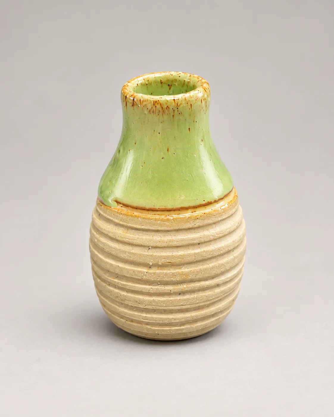 Bud vase with green glazed neck and ribbed unglazed body