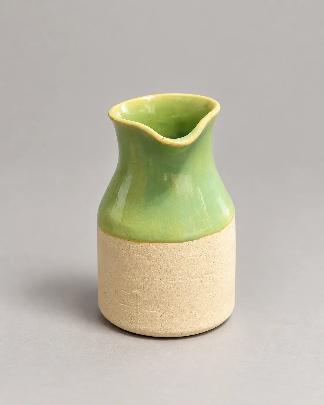 Small pour vase with green glazed top and raw clay base